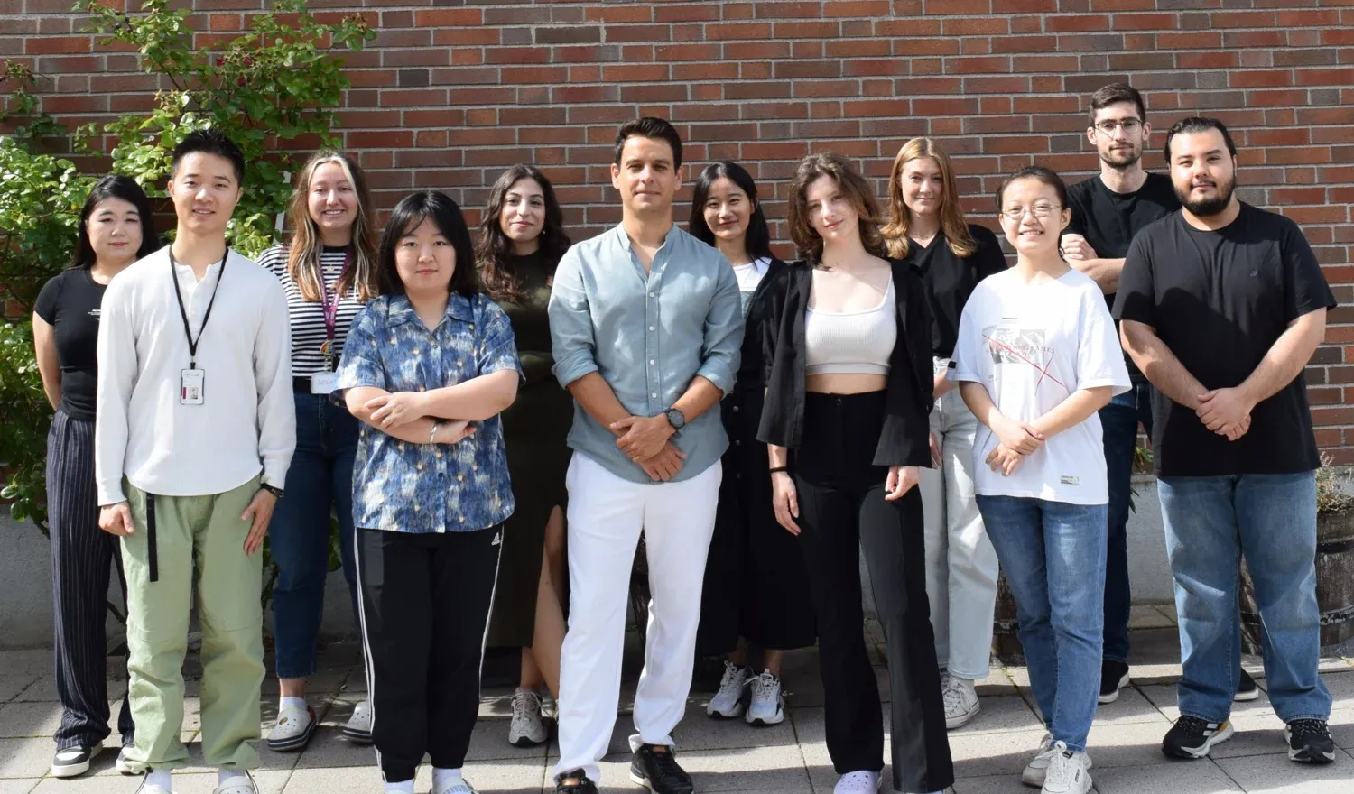 Team Onur Parlak in front of a red brick building.