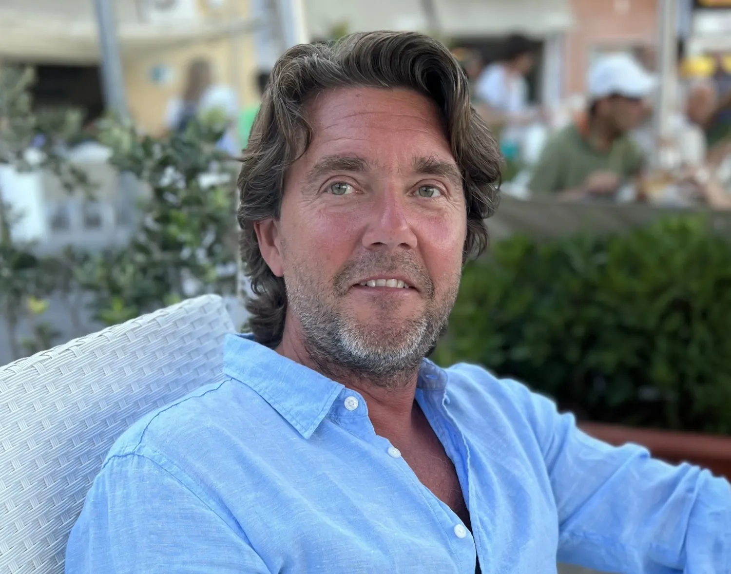 Portrait of a man in a light blue shirt.