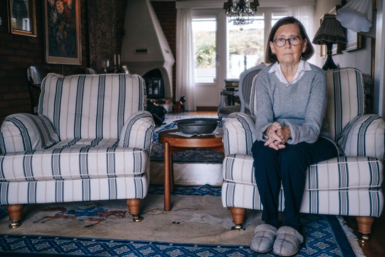 Margareta sitting in a couch in her living room.