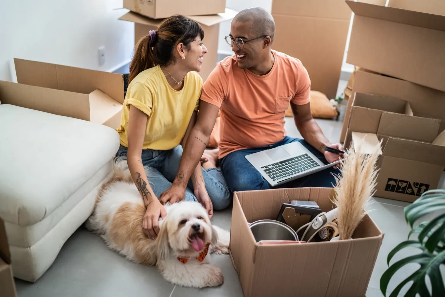 Young couple packing and moving boxes at home.