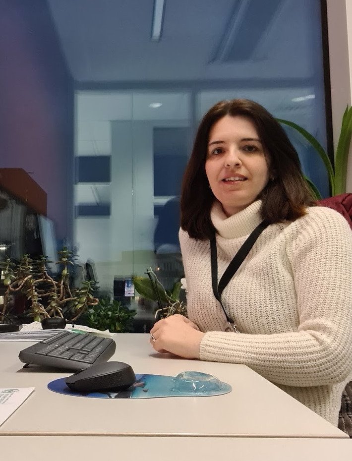 Ourania Kostopoulou sitting at her desk.