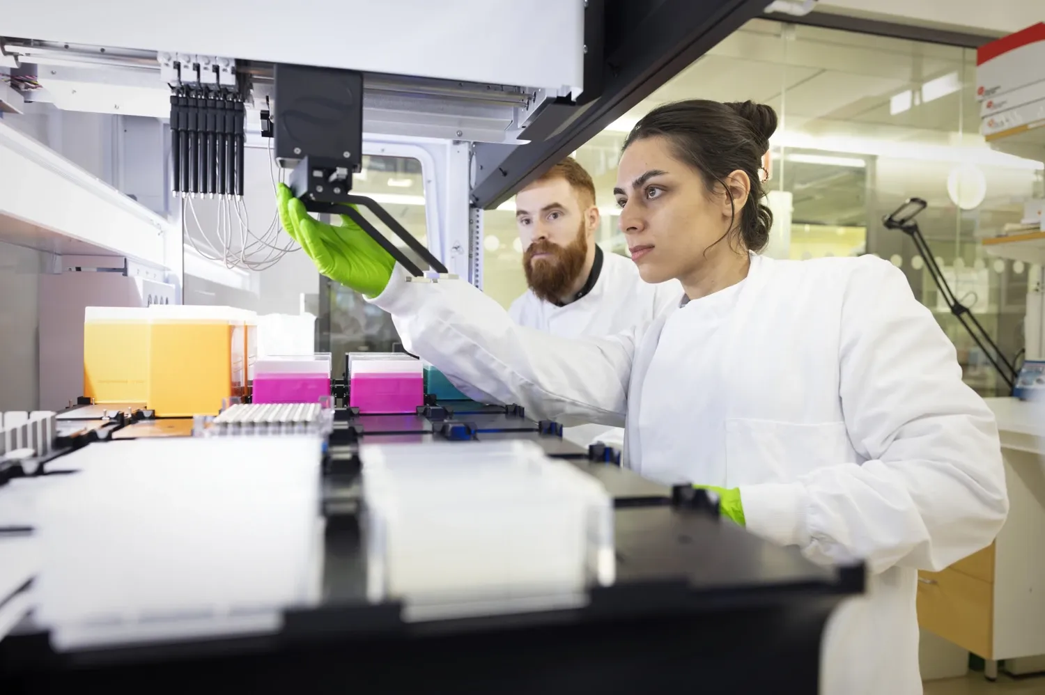 Researchers working at the Biomek i7 robot.