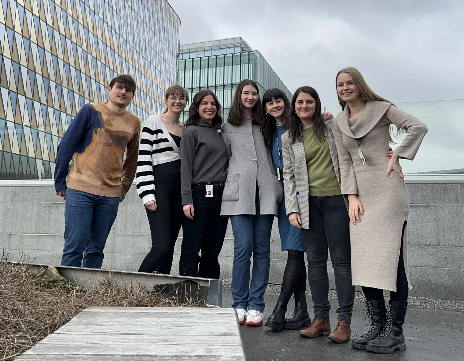 peopla standing in front of glass building