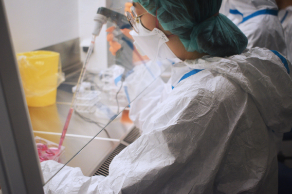 High-security lab environment, people working in the lab.