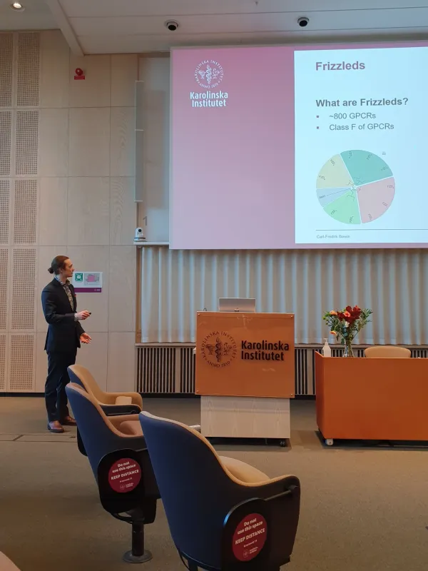 A picture of Carl Bowin in front of his presentation