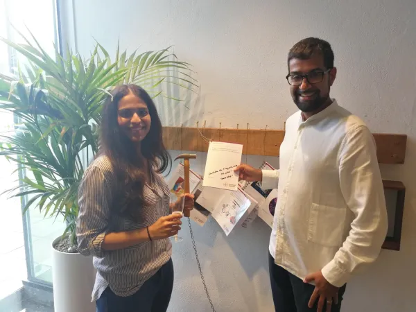 Samudyata spiking her thesis into a plank, together with Goncalo Castelo-Branco.